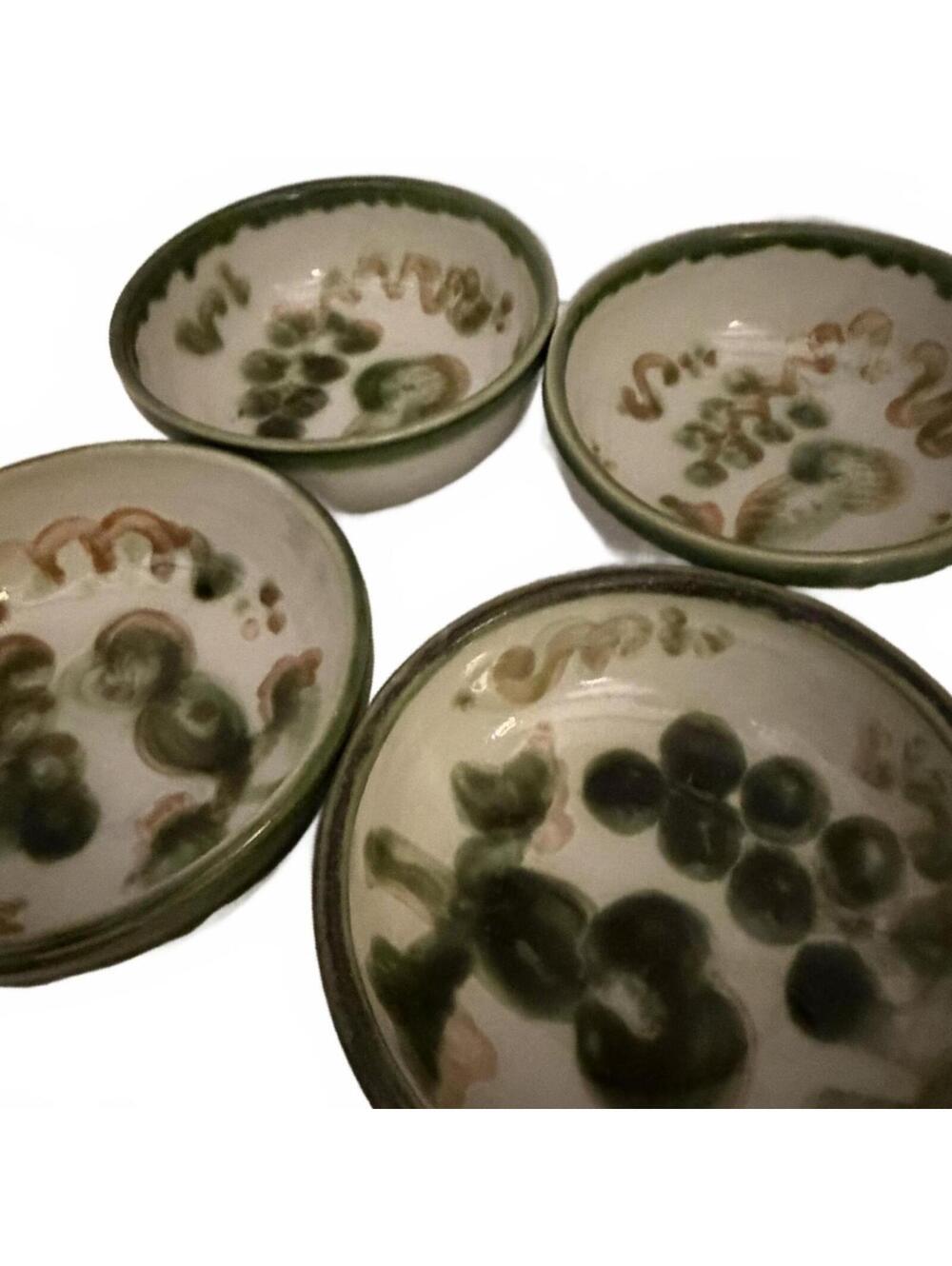 Set of four Mary Hadley hand-painted earthenware bowls with grape motif.